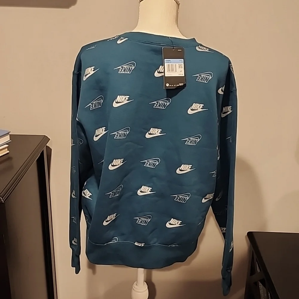 Nike sweatshirt teal w/ silver Nike size medium bust 23 in. Length 25 in.